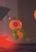 The Halloween Orange Pumpkin Voodoo Doll on display in the Halloween Shop.