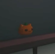 The Pumpkin Kitty Plushie on display in the Asylum shop.