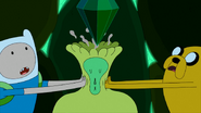 Finn and Jake squeezing the crown out of Emerald Princess' head