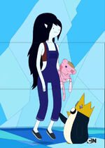 Gunter pokes at Marceline's leg