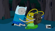 S4e7 finn and jake holding the enchiridion