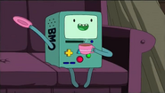 BMO about to throw plate at Finn in the Jakesuit