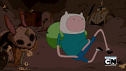 S3e2 Finn next to rabbit skeleton