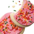Cookies with pink frosting and rainbow sprinkles.