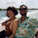 The singer Miguel chilling on a boat covered in some designer Vacation Dadcore attire.