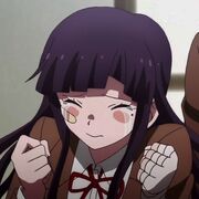 Screenshot of Mikan Tsumiki from Danganronpa. She has purple hair and has her eyes shut with tears streaming down her face. She also has a band-aid and blush on her cheeks.