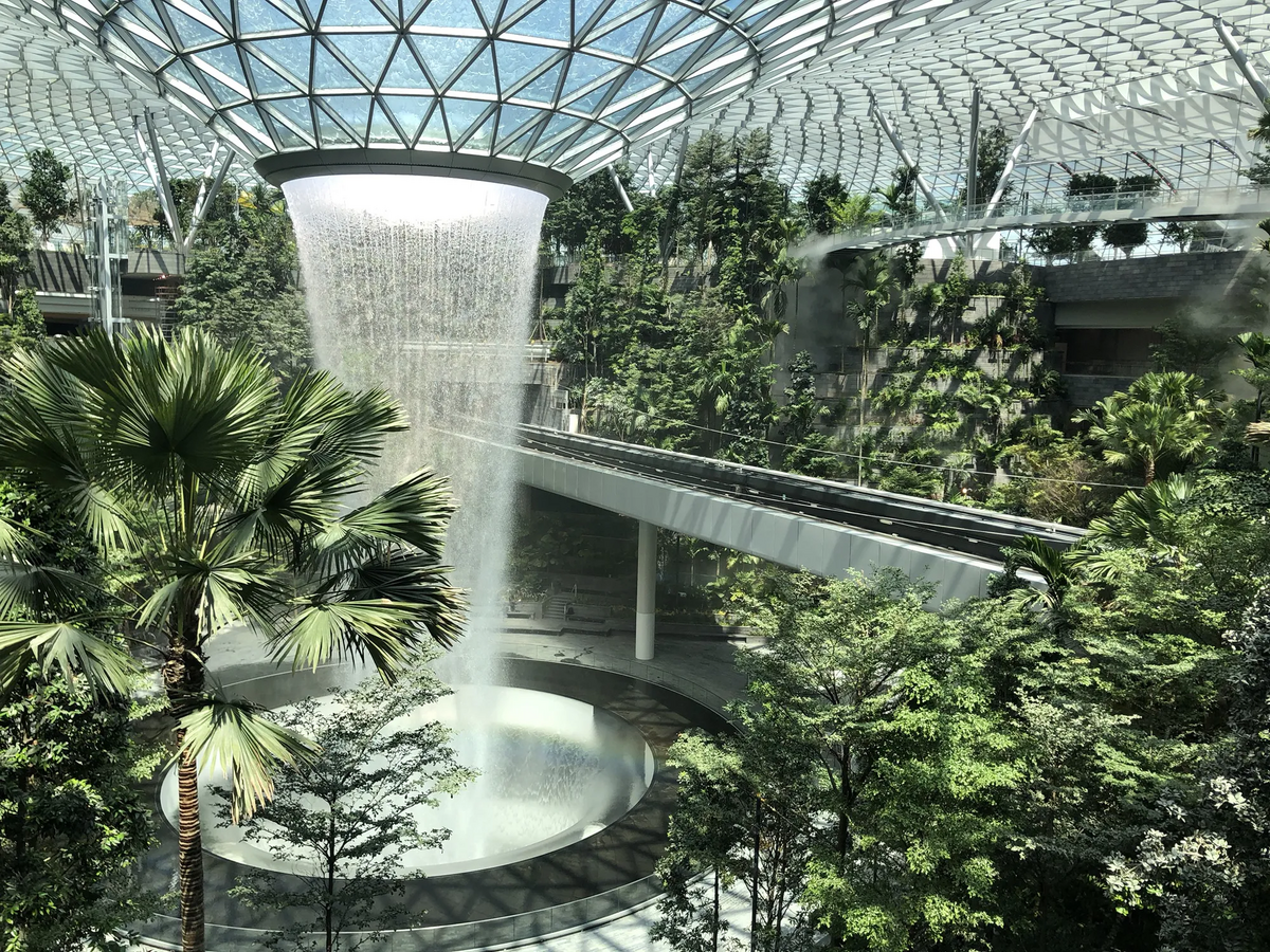 A solarpunk city with white skyscrapers, plants and the ocean nearby