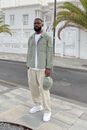Minimalist male outfit in green, white and beige