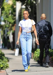A woman in a white tee and light blue jeans