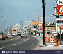 D1970s-suburban-shops-fast-food-motels-gas-busy-clutter-signs-americana-DBXBCN