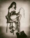 Bettie Page holding whip