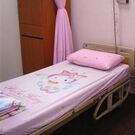 A cute hospital bed with a Hello Kitty print on it.