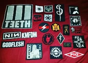 A collection of patches featuring the icons of various industrial bands.