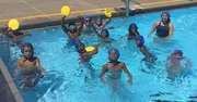 "S" for "SKWIM"  Squad sends a salute to signal some serious summer fun at . The yellow foam swim disks, aquatic frisbees, were part of the game-play