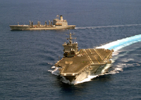 The HMS Illustrious (NR-01) at sea with a fleet replenishment oiler.