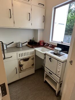 The gallery has a mock up kitchen showing how it would have looked like in Christie's time. The hatch to the right of the sink is the oven. To the left, at right angles is another hatch--that is actually a fridge!