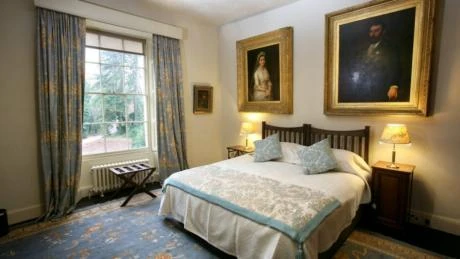 A Bedroom. Note the painting's of Agatha's parents, Clarissa and Frederick