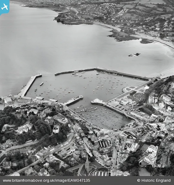 The best way to appreciate Princess Pier is from the air. In this 1952 aerial photo, Princess Pier is the long, dog-leg shaped pier on the right. The circular structures are Princess Gardens. The Torquay Pavillion is also visible next next to the gardens.