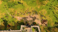 A bird's-eye view of a Mongolian siege upon an English town in Age of Empires IV.