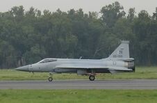 Side view of JF-17 taxiing with trucks in background cropped version-1-