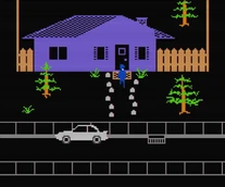 Outside of John's house. Note that the car is moved a bit to the left, and there is a carpet next to the door, and rocks in front of it.