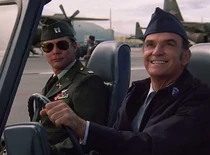 Gene Bicknell as a jeep driver seen here with the undercover Hawke. He is admiring a formation of jets overhead. Hawke addresses him as "Chief".