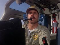 Kevin N. La Rosa as the police pilot who lands at the scene of Chester's murder.