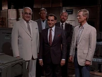 A group of buyers interested in Kruger's offer of Thor missiles. The one in the center is credited as Elias Zarou. At the right is Minter, Kruger's assistant. Right behind, is Tony Epper.