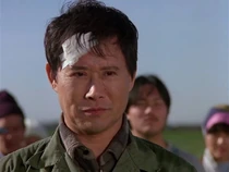 Nguyen Van Minh, a former war hero who swore off violence. Here he has regained his confidence and confronts Zung.