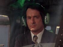 Steve Chambers as Shecter, one of Jake's hitmen. He is flying the Bell 205 with Caitlin and Kevin tied up in the back.