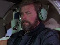 We assume this is Jerome Blackwell, credited as "pilot". He flies in the Hughes equipped with "Loki".
