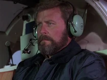 We assume this is Jerome Blackwell, credited as "pilot". He flies in the Hughes equipped with "Loki".