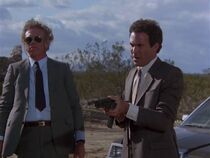 A pair of Langhorn hitmen. Stark (Dean Wein) on the right with gun. Tony Epper (left) is not credited but is listed in the Airwolf Series Guide as Rayco. He has quite a few lines in the episode.