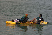 Two Interesting Ladies Lean Back in a Dual Kayak