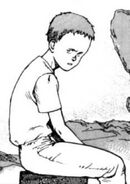 Closeup of Tetsuo sitting alone