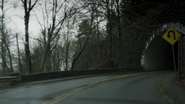 Jake's car approaches a tunnel.