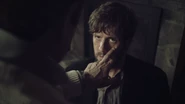 Dr. Hartman checks Jake's eye.