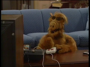 ALF playing Space Invaders on the Atari.