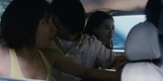 Arisu and the others in the car trying to escape from the King of Spades