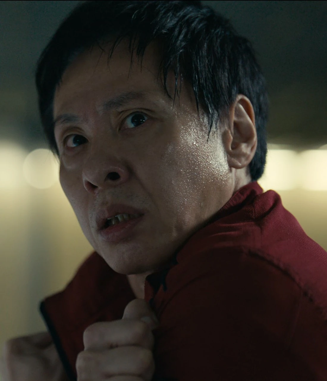 A close-up shot of Tetsu with a tense and determined expression