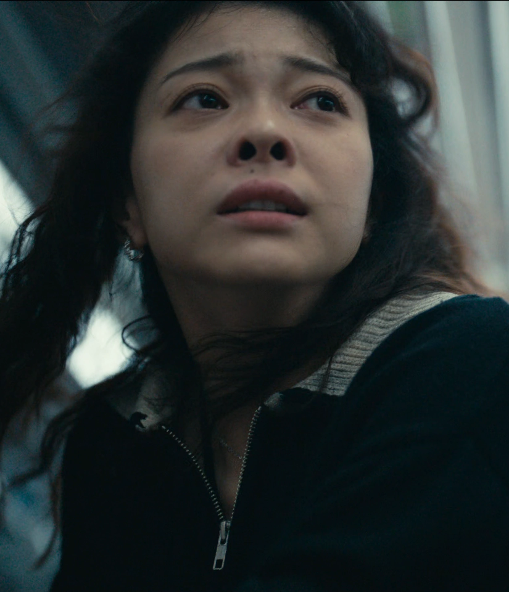 A screenshot of Himari from Season 3, a young woman with long wavy hair, looking aside with a scared but hopeful expression
