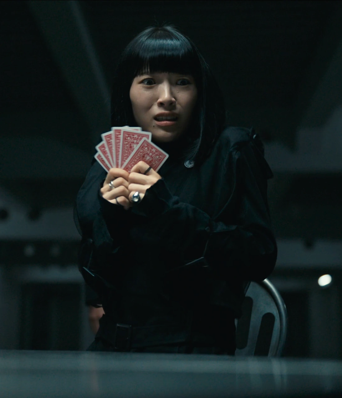 A screenshot of an unnamed player from Season 3, a woman with black hair, wearing an all black outfit