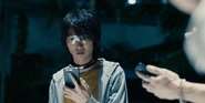 Arisu looking at his phone during the "Hide and Seek" game