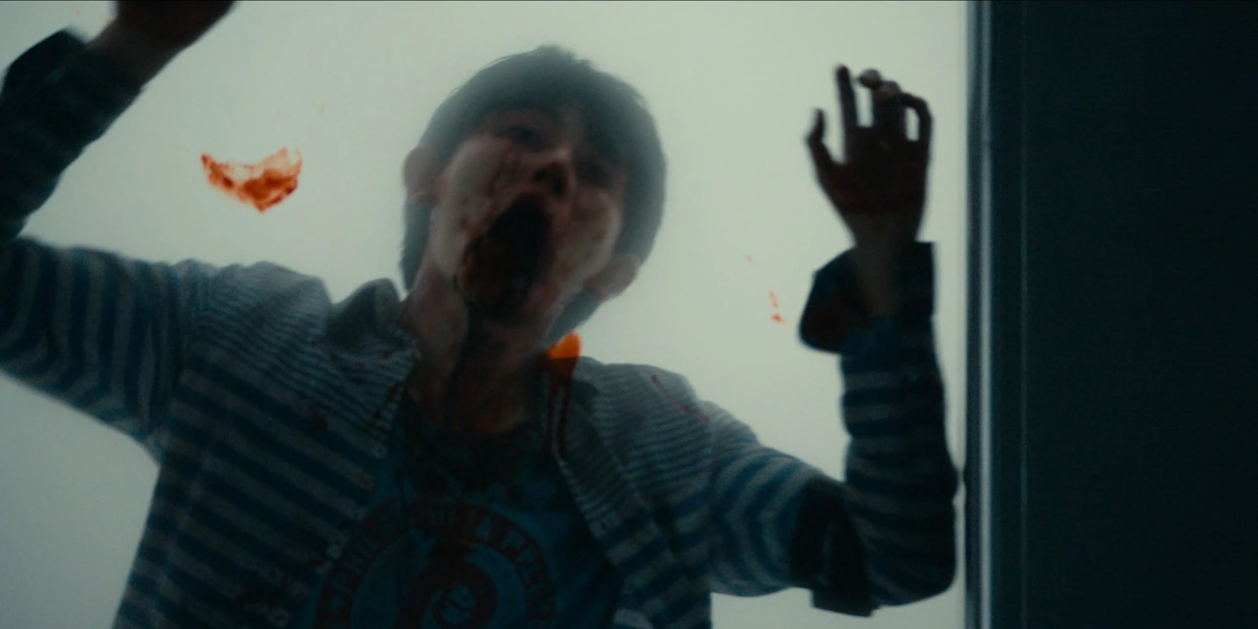 A screenshot of an unnamed male player leaning onto a train window and coughing blood