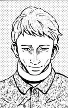 A cropped bust shot of a man named Sunato Banda with light-colored hair, wearing a grey shirt, giving a sociopathic look by staring at the viewer with a Kubrick Stare—his head tilted down, eyes glaring upward