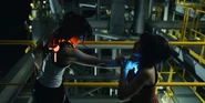 Risa choking Usagi, they are both wearing game equipment glowing with opposite colors