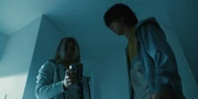 Chishiya looking at his taser after temporarily taking out Horse Head