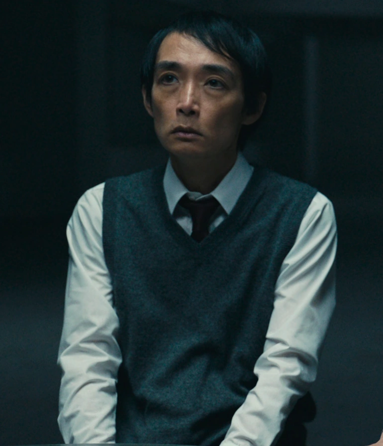 A screenshot of an unnamed player from Season 3, an older man with short hair, wearing a classic white shirt with a gray wool vest over it