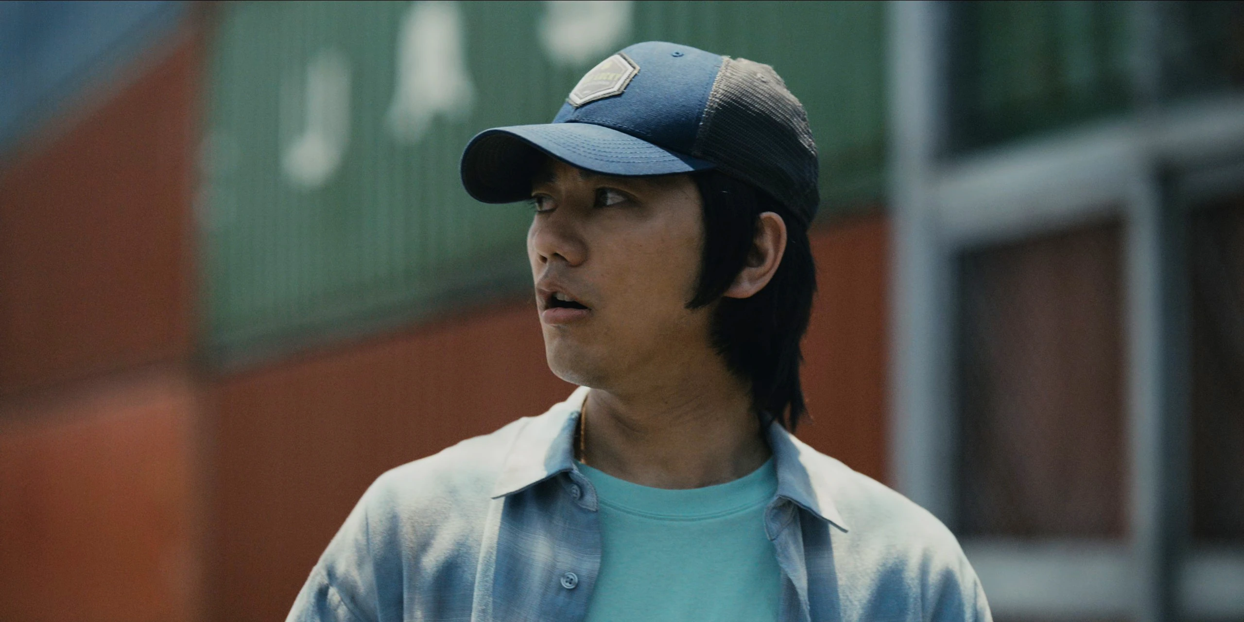 A screenshot of Tatta Kodai from Season 2, a young man wearing a blue shirt and a cap