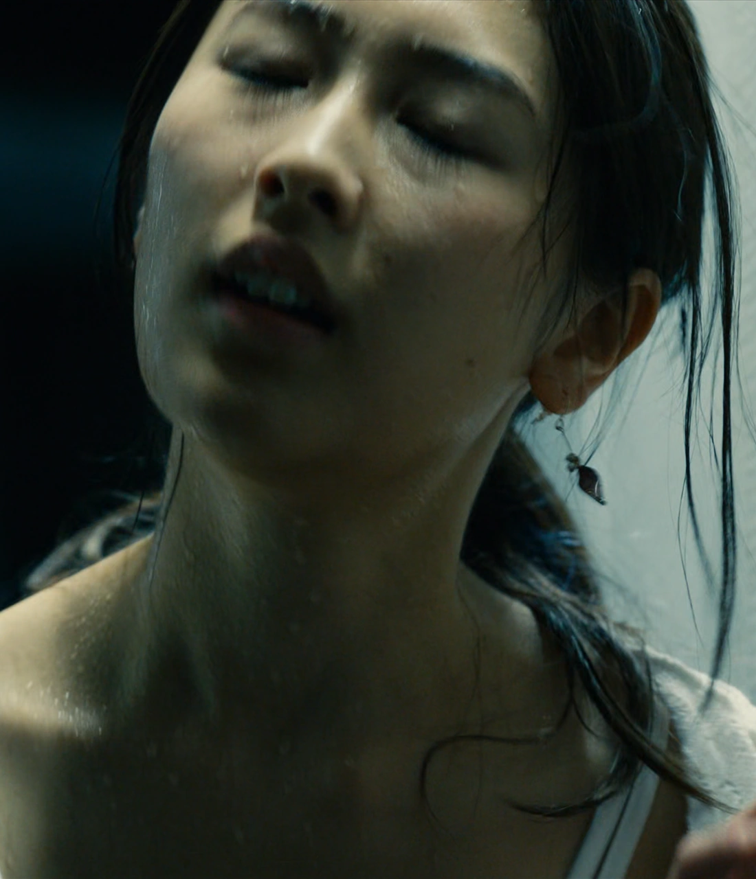 A close-up shot of Yui, exhausted and drenched in sweat while catching her breath